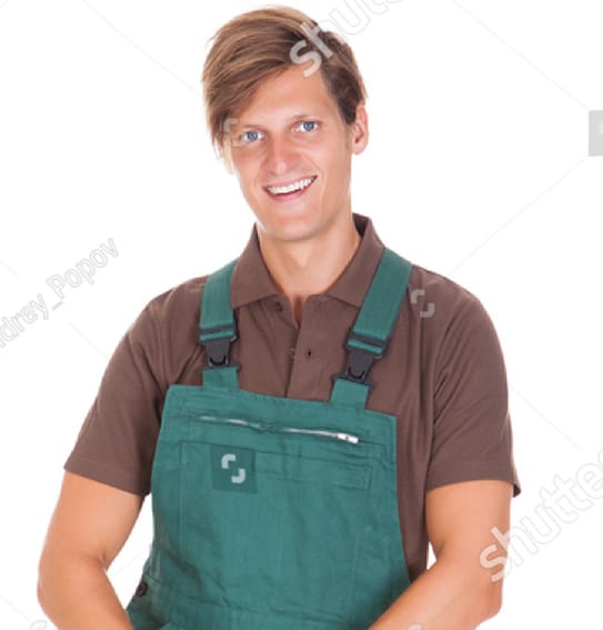 a man wearing a green apron and smiling.