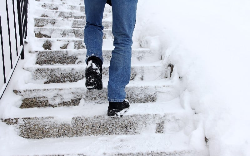 winter dangerous walk snow covered staircase man walks staircase winter